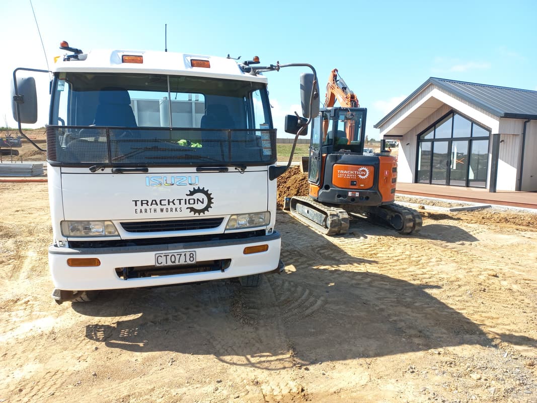 Isuzu tipper truck and excavator at a new build